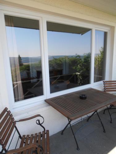 a screened in porch with a table and two chairs at Einbecker Sonnenberg in Einbeck