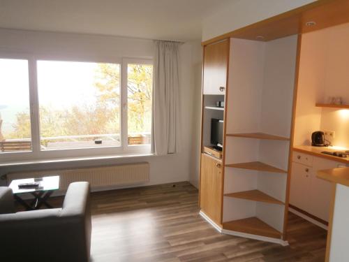 a living room with a kitchen and a window at Einbecker Sonnenberg in Einbeck