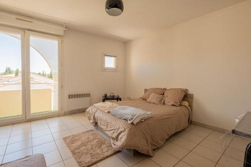 Cama o camas de una habitación en Grand appartement Le Prado avec terrasse