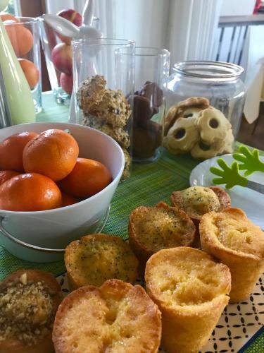 a table with a plate of food and a bowl of fruit at Hotel Erika in Malcesine