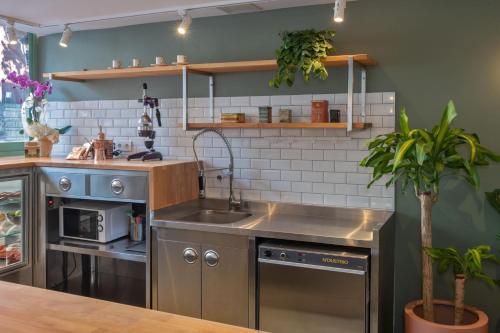 a kitchen with a sink and a stove at Nika otel & cafe in Istanbul
