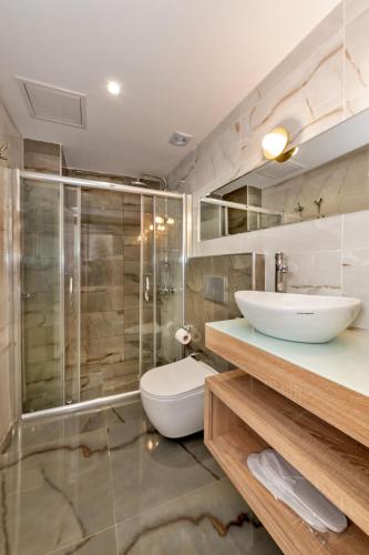 a bathroom with a toilet and a sink and a shower at Nika otel & cafe in Istanbul