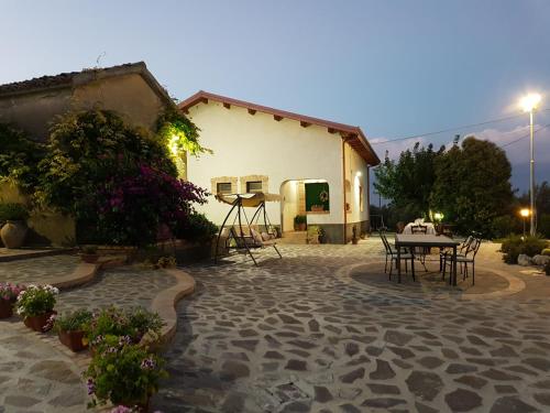 a patio with a table and chairs in front of a building at Borgo Santa Lucia in Cropani