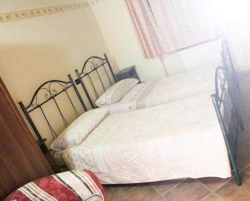 2 camas individuales en un dormitorio con ventana en La Fattoria en Cusano Mutri
