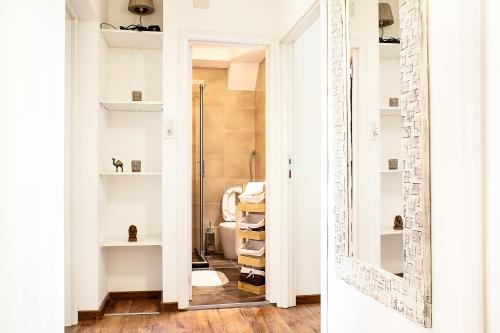 a bathroom with a glass door leading to a shower at City Place Apartments in Belgrade