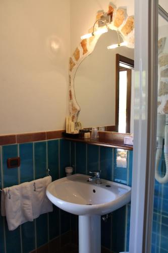 a bathroom with a sink and a mirror at Luagos club Resort in Lampedusa