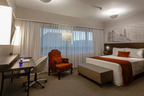 a hotel room with a bed and a desk and a chair at Blue Tree Premium Paulista in São Paulo