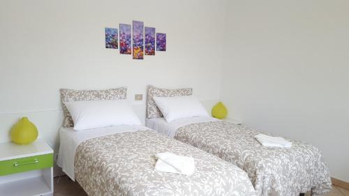 Posteľ alebo postele v izbe v ubytovaní Terrazza Zèfiro Casa vacanze