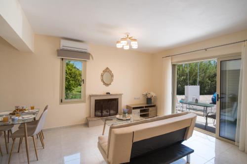 a living room with a couch and a fireplace at Bounatsa Studios & Apartments in Nydri