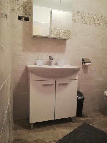 a bathroom with a sink and a mirror at Apartment Marina in Malinska