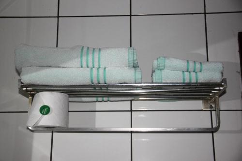 a metal towel rack with towels on it in a bathroom at Infinity Copacabana in Rio de Janeiro