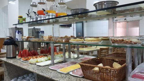 a kitchen with many plates of food on a counter at Hotel Único in Rio de Janeiro