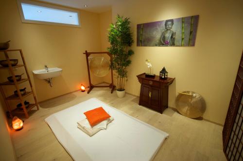 a room with a white table and a sink and a mirror at Seehotel OFF in Meersburg