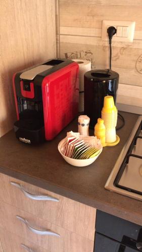 a counter with a toaster and a coffee maker on it at B&B Trieste Caltanissetta in Caltanissetta