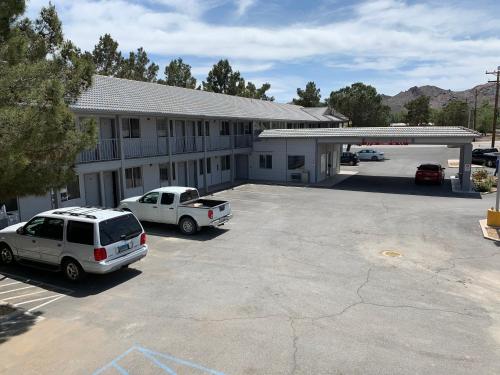 a large parking lot in front of a building at Exchange Club Motel in Beatty