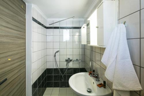 a bathroom with a sink and a shower at Kolimbito Sea Side in Falasarna
