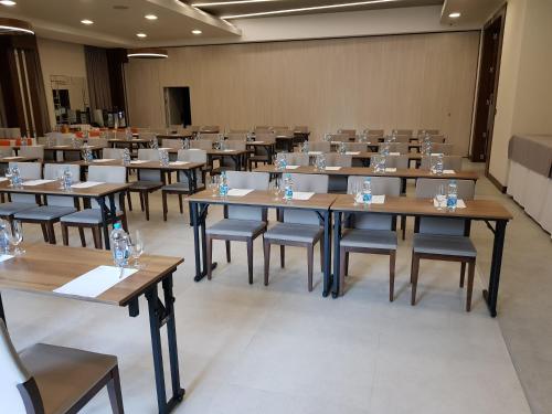 a large room with tables and chairs in it at Hotel Na Półboru in Sieradz