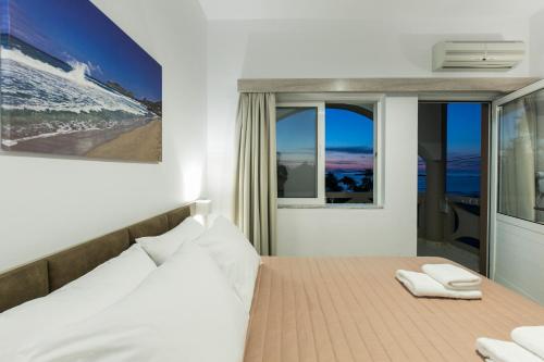 a bedroom with a bed with two towels on it at Kolimbito Sea Side in Falasarna