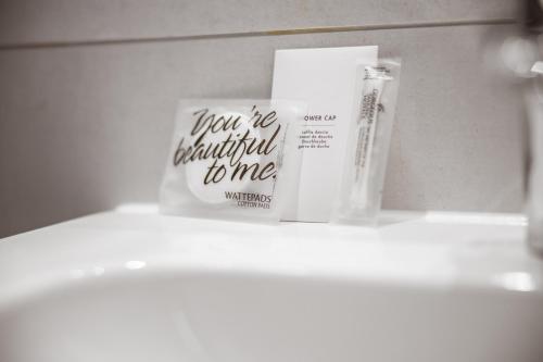 a shelf with a book and other items on it at Maison Schiller by DesignCity Hotels in Munich