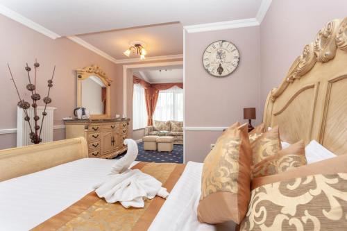 a bedroom with a bed and a clock on the wall at Winter & Summer Resort in Ždiar
