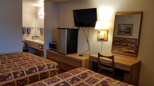 a hotel room with two beds and a sink at Royal Motor Inn in La Grande