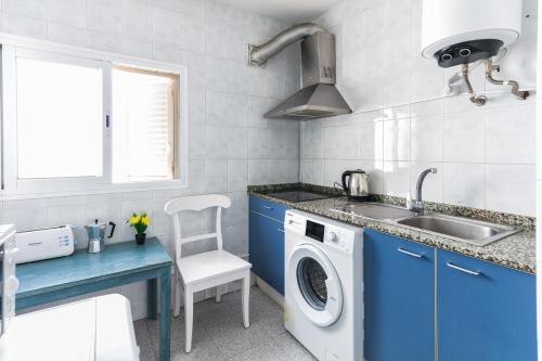a kitchen with a washing machine and a sink at PARADISE IBIZA ( Apto. Turístico 1 llave ) in San Antonio