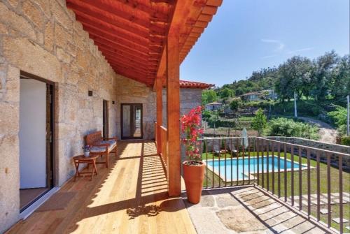 an external view of a house with a swimming pool at Mariana's HeartMade House in Caldelas