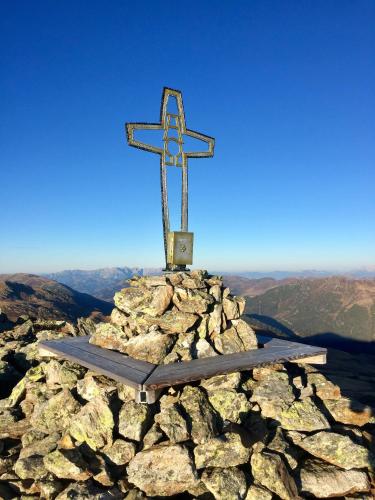 a cross on top of a pile of rocks at Landhaus Rosengartl Krimml in Oberkrimml