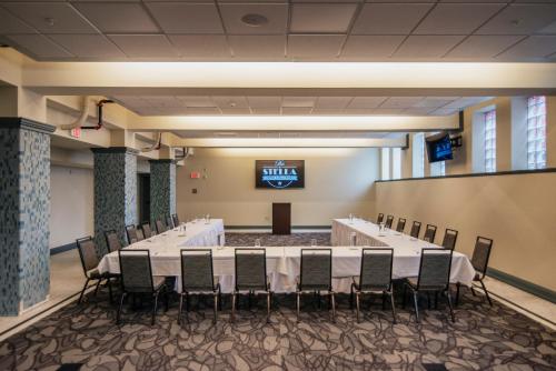 a conference room with a long table and chairs at The Stella Hotel & Ballroom in Kenosha