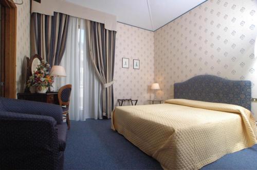 a hotel room with a bed and a window at Hotel Nuovo Rebecchino in Naples