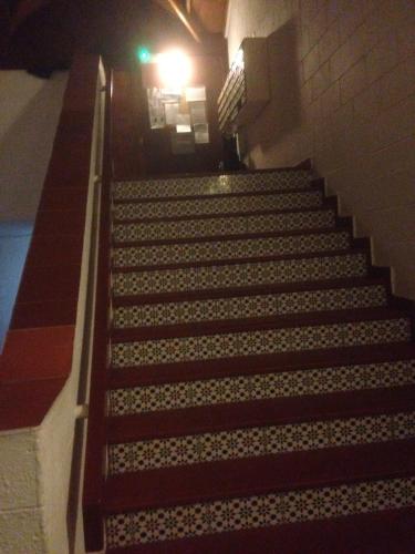 a set of stairs in a building with a green light at Arcadia 408 in Gibraltar