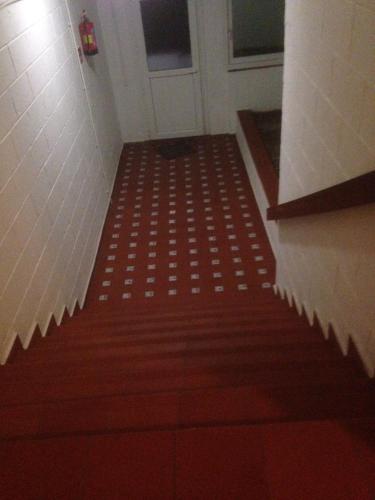 a stairway with a red and white patterned carpet at Arcadia 408 in Gibraltar
