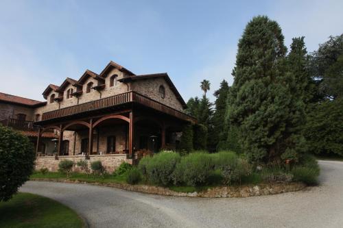 a large house with a porch on a road at Jardin de Carrejo in Cabezón de la Sal