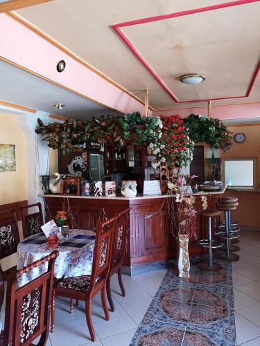 a restaurant with a bar with a table and chairs at Biela Labuť in Michalovce