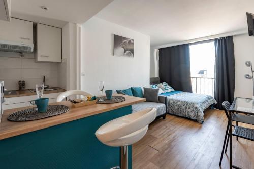 a kitchen and living room with a couch and a table at Hypercentre 200M Cathedrale/Train station + private parking* in Reims