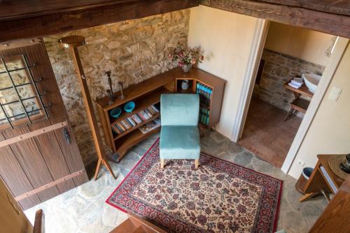 an overhead view of a living room with a chair at Paradosiako Saratsi - Traditional Guest House in Volos