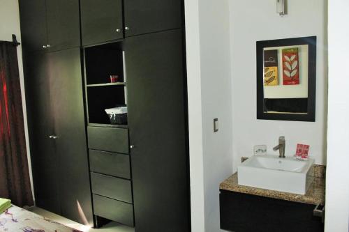a bathroom with a sink and a cabinet at Maya Vacanze Playa Quinta B&B in Playa del Carmen