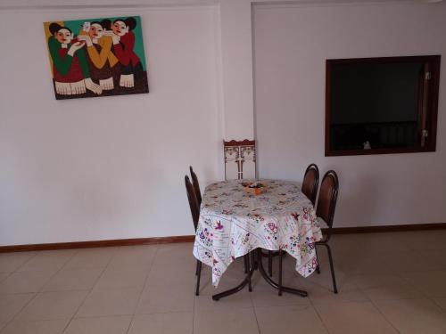 a table and chairs with a table and a painting on the wall at Prothea Home in Vila Chã