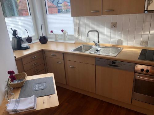a kitchen with a sink and a counter top at Ferienhaus am Emmerbach in Ascheberg