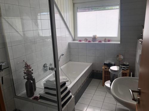 a bathroom with a bath tub and a sink at Ferienhaus am Emmerbach in Ascheberg