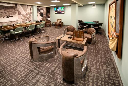 a waiting room with couches and tables and chairs at The Stella Hotel & Ballroom in Kenosha