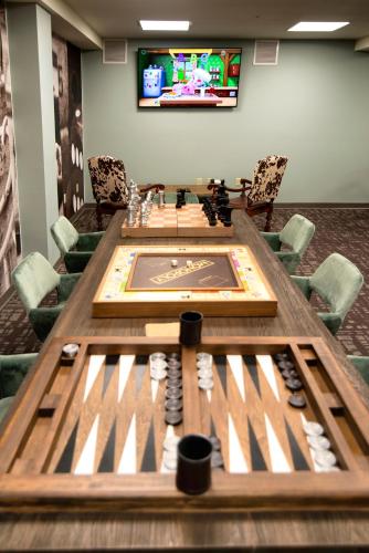 a conference room with a table and a tv at The Stella Hotel & Ballroom in Kenosha