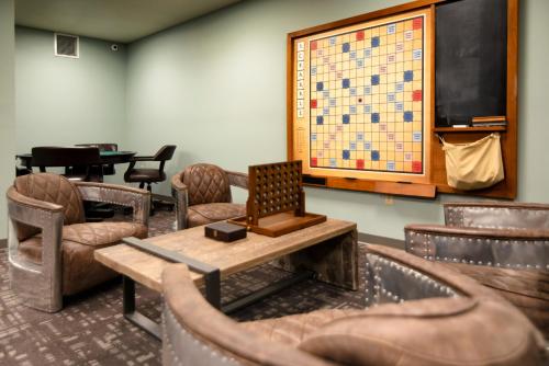 a waiting room with chairs and a table and a board at The Stella Hotel & Ballroom in Kenosha