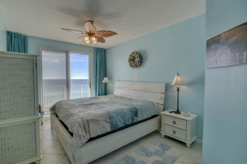 a bedroom with a bed and a window and a ceiling fan at Majestic Sun 913A Miramar Beach (Condo) in Destin