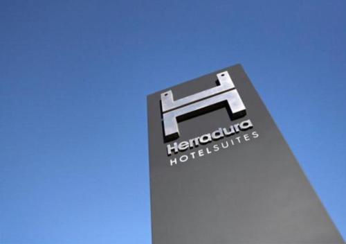 a sign for a thermospheric industries sign on a building at Herradura Hotel Suites in Neuquén