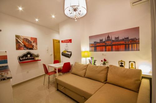 a living room with a couch and a table at Apartamentos El Templo Suites in Merida