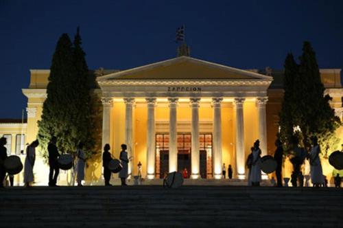 a building with people standing in front of it at night at Beautiful studio next to ancient stadium in Athens