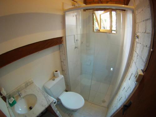 a bathroom with a shower and a toilet and a sink at Caza Floripa in Florianópolis