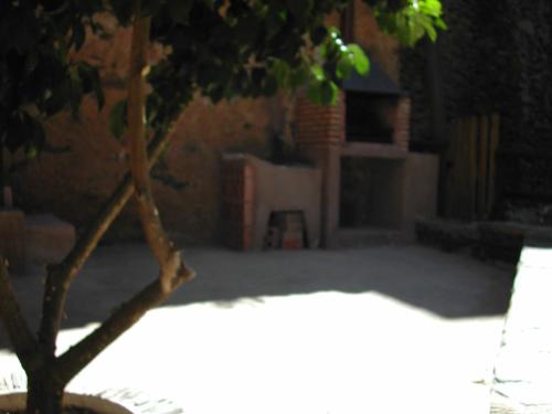 a view of a backyard with a tree in the foreground at Casa Rural Valle del Arrago in Robledillo de Gata