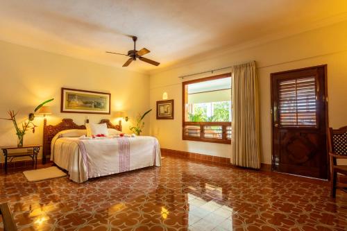 a bedroom with a bed and a window at Hacienda Uxmal Plantation & Museum in Uxmal